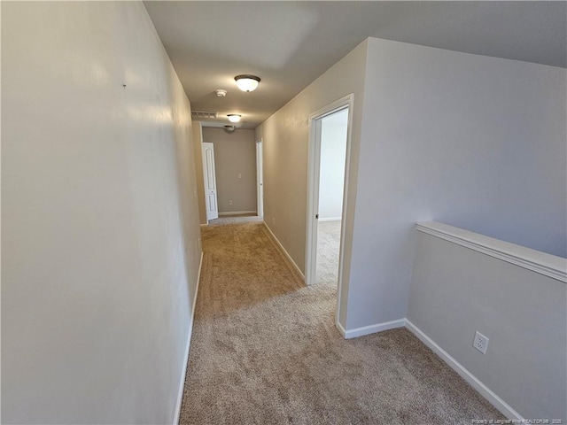 hall with baseboards and carpet floors