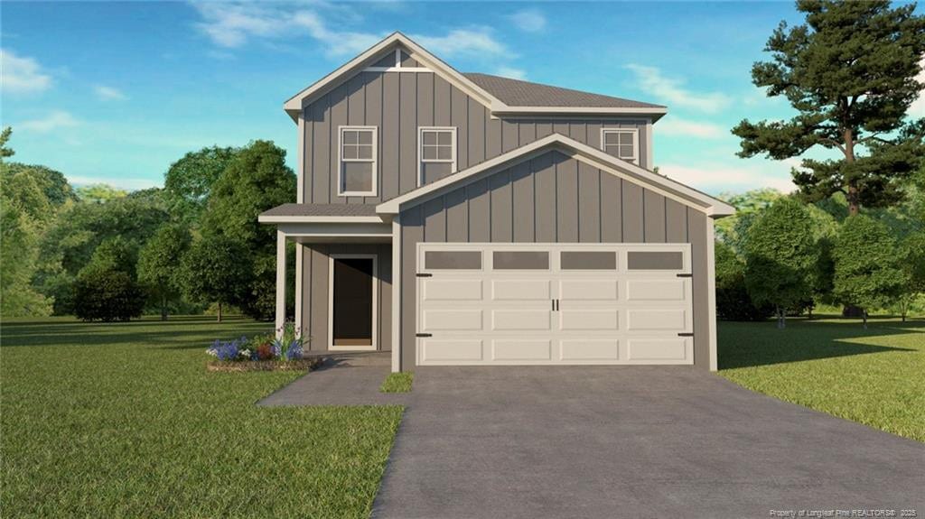 view of front of property with a front yard, an attached garage, board and batten siding, and driveway