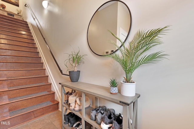 stairs with tile patterned floors