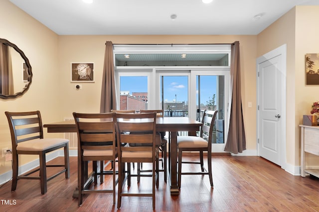 dining space with wood finished floors and baseboards