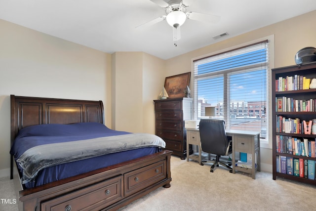 bedroom with visible vents, light colored carpet, and ceiling fan