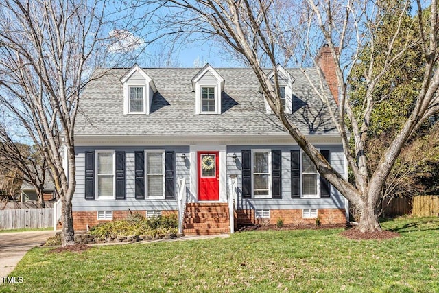 new england style home with fence, a front yard, a shingled roof, crawl space, and a chimney