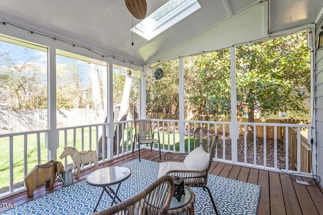 sunroom with vaulted ceiling with skylight