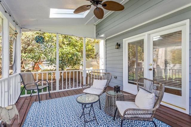 sunroom / solarium featuring lofted ceiling and a ceiling fan