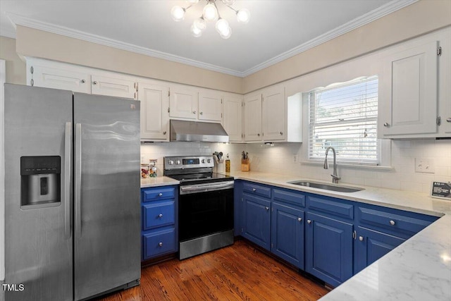 kitchen with ornamental molding, under cabinet range hood, blue cabinetry, a sink, and stainless steel appliances