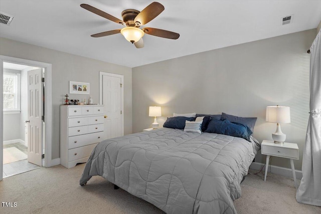 bedroom featuring baseboards, light carpet, visible vents, and ceiling fan