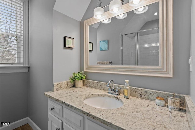 full bathroom featuring a shower stall, vanity, and baseboards