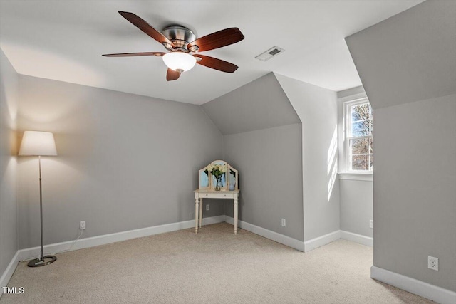 additional living space featuring a ceiling fan, baseboards, visible vents, carpet floors, and lofted ceiling