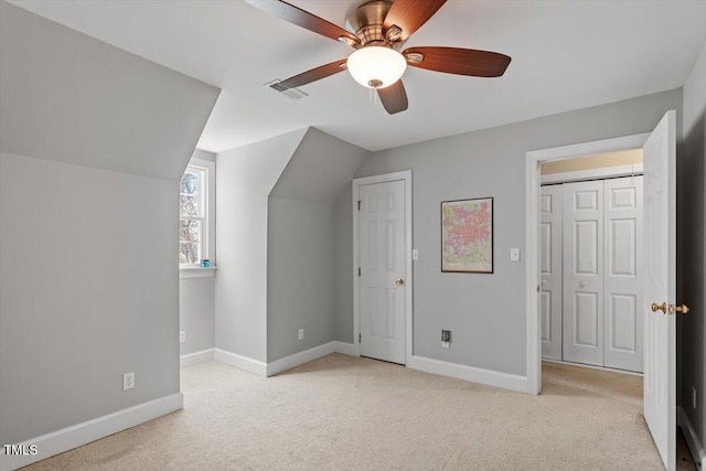 bonus room with carpet, visible vents, baseboards, lofted ceiling, and ceiling fan