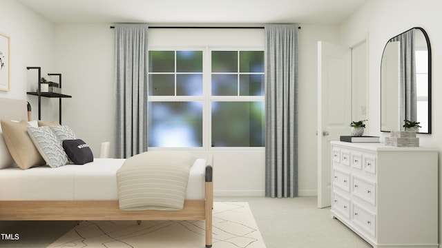 bedroom with light colored carpet and baseboards