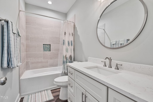 full bath featuring shower / bath combo with shower curtain, toilet, vanity, and wood finished floors