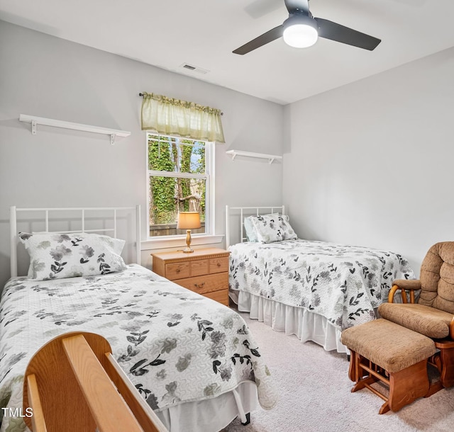 bedroom with carpet flooring, a ceiling fan, and visible vents