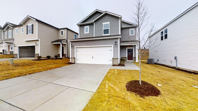 view of front of property with stone siding, concrete driveway, a front yard, an attached garage, and central AC unit