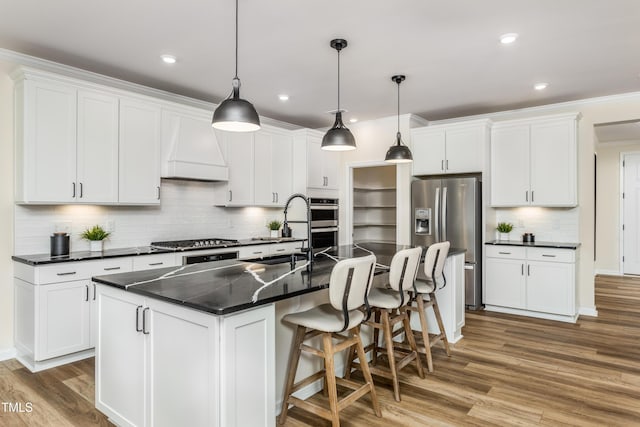 kitchen featuring a sink, dark countertops, custom range hood, and stainless steel appliances