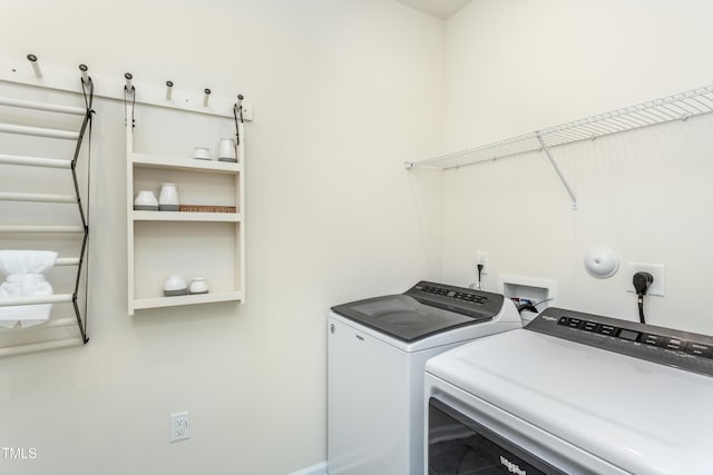 clothes washing area featuring laundry area and separate washer and dryer