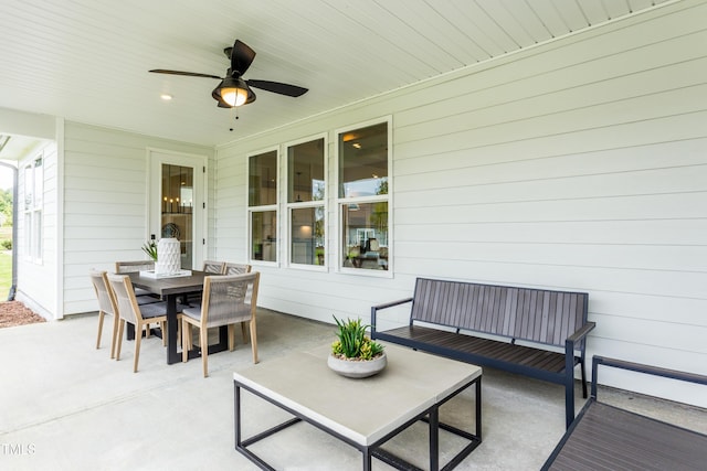 view of patio with outdoor dining space and a ceiling fan