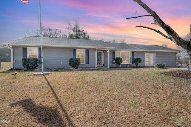 single story home featuring a front yard