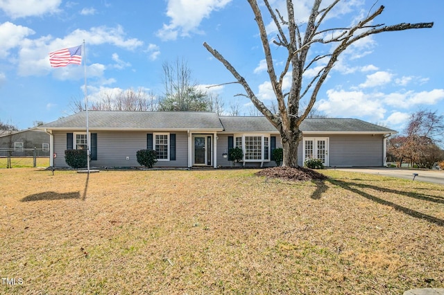 single story home featuring a front lawn and fence