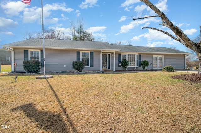 single story home featuring a front yard and french doors