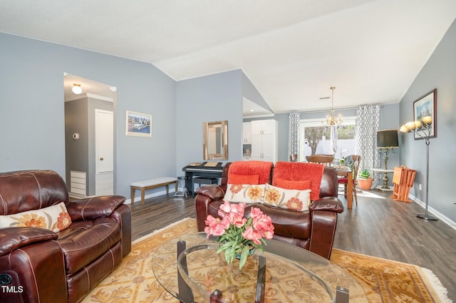 living area with a chandelier, wood finished floors, baseboards, and vaulted ceiling