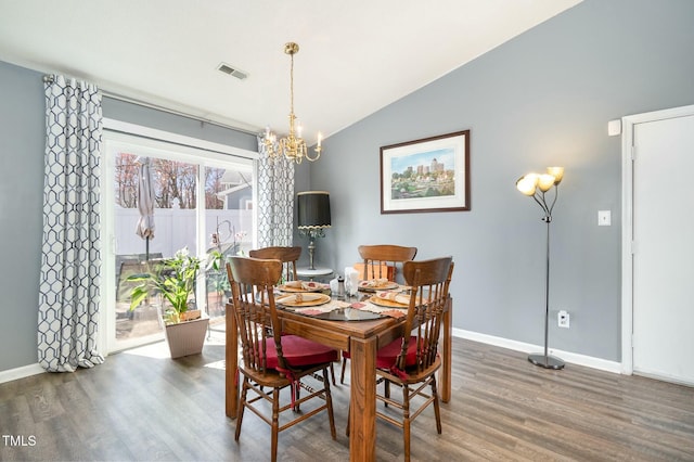 dining area featuring visible vents, baseboards, vaulted ceiling, wood finished floors, and a notable chandelier