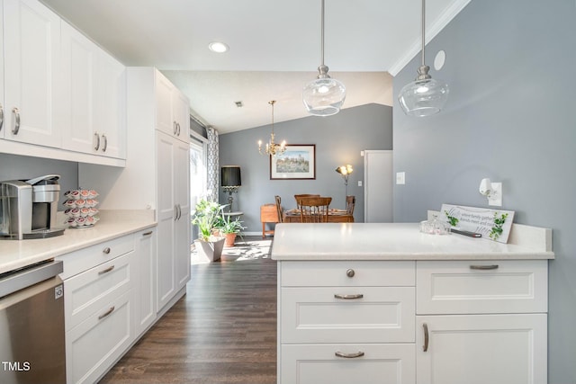 kitchen featuring light countertops, lofted ceiling, stainless steel dishwasher, white cabinets, and dark wood-style flooring