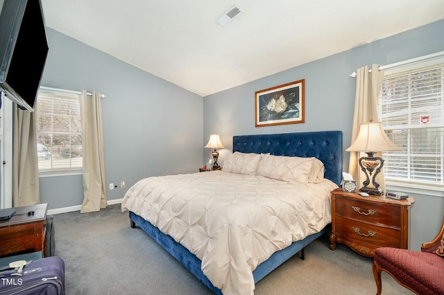 bedroom with vaulted ceiling, multiple windows, visible vents, and carpet floors