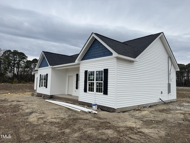 view of front of house with roof with shingles