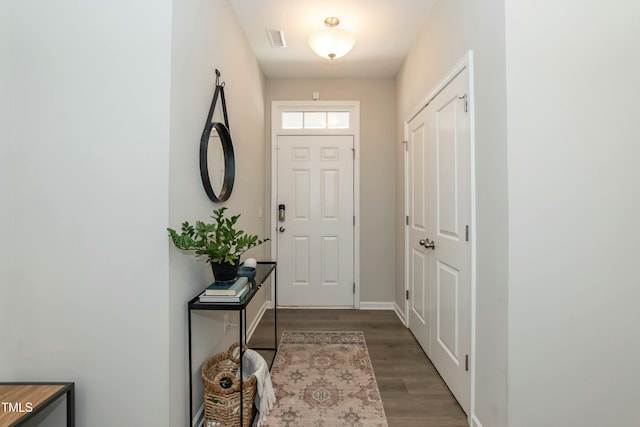 entryway with wood finished floors, visible vents, and baseboards