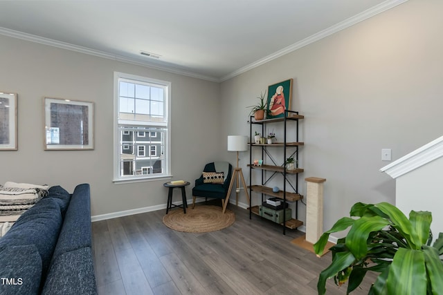 sitting room featuring visible vents, baseboards, dark wood-type flooring, and ornamental molding