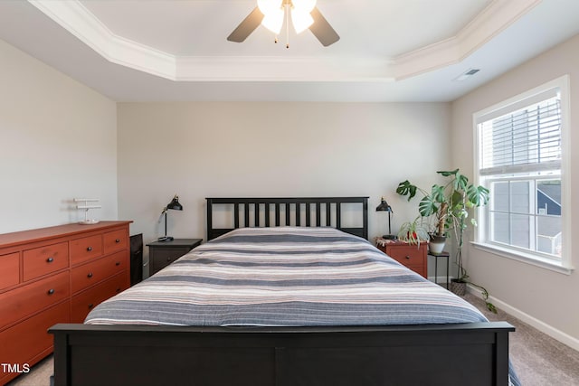 bedroom featuring light carpet, visible vents, a raised ceiling, and baseboards