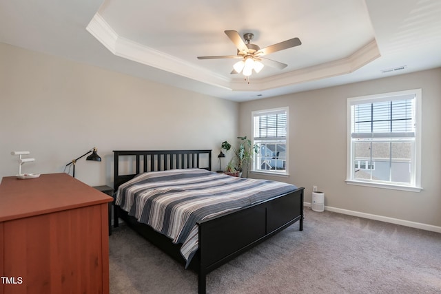 bedroom with baseboards, carpet floors, a tray ceiling, ceiling fan, and crown molding