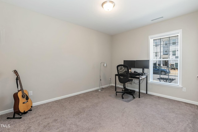 carpeted office space with visible vents and baseboards