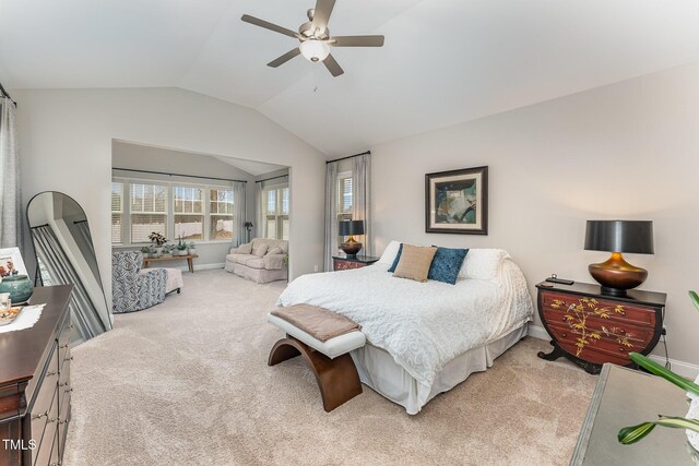 bedroom featuring baseboards, light carpet, a ceiling fan, and vaulted ceiling