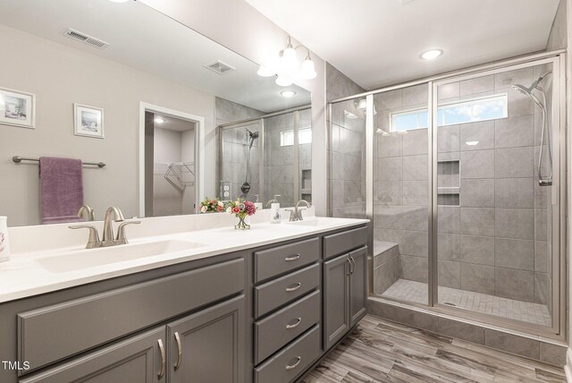 full bath featuring visible vents, a stall shower, and a sink