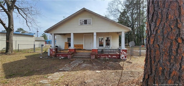 bungalow with a porch and fence