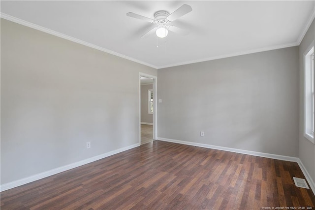 unfurnished room featuring visible vents, crown molding, ceiling fan, dark wood-type flooring, and baseboards