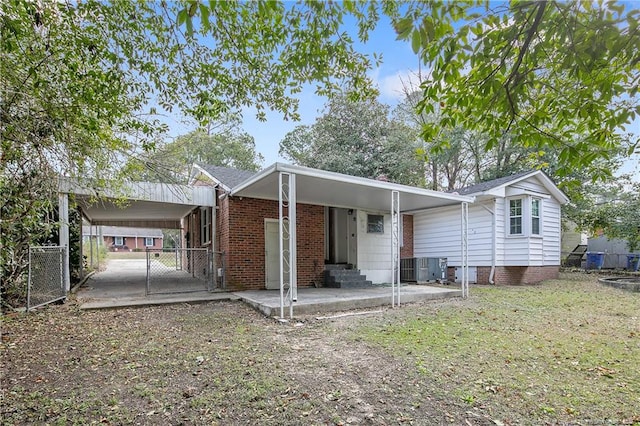 view of front facade with entry steps, cooling unit, fence, and brick siding