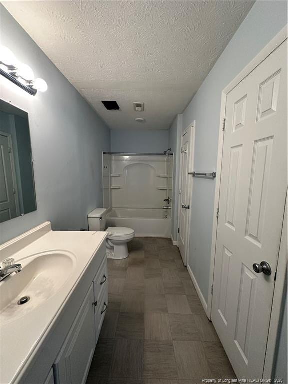 bathroom featuring visible vents, toilet, a textured ceiling, tub / shower combination, and vanity