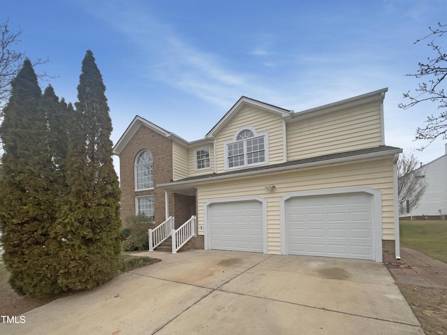 traditional-style home featuring a garage, brick siding, and concrete driveway