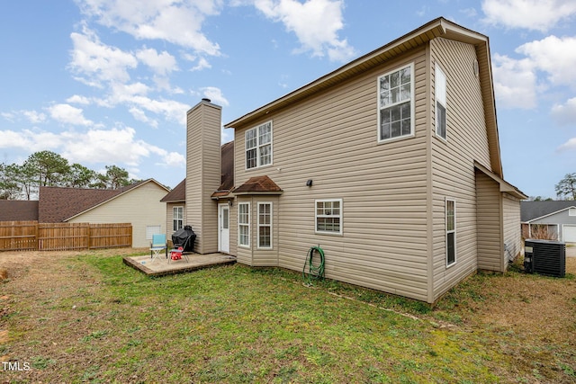 rear view of property with a patio, cooling unit, fence, a chimney, and a lawn