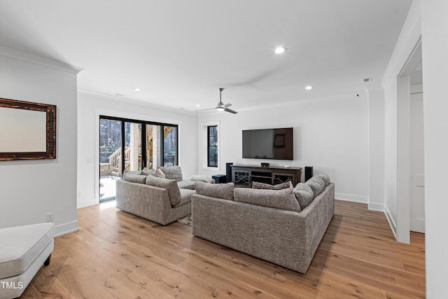 living area with crown molding, recessed lighting, light wood-style floors, and baseboards