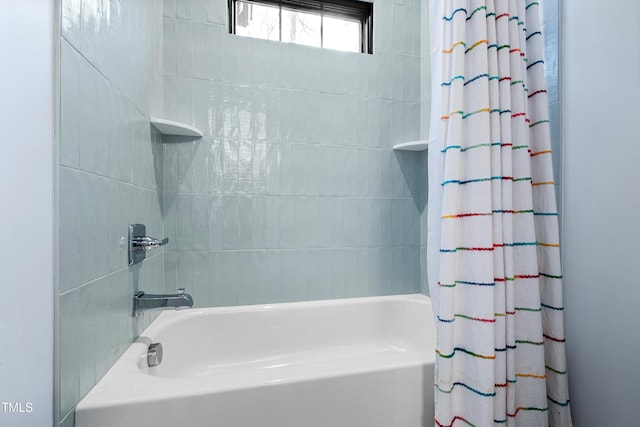 bathroom with shower / bath combo with shower curtain