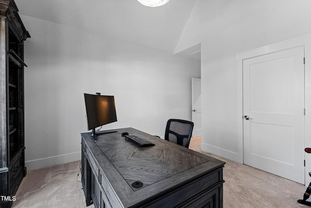 home office featuring baseboards, light colored carpet, and vaulted ceiling