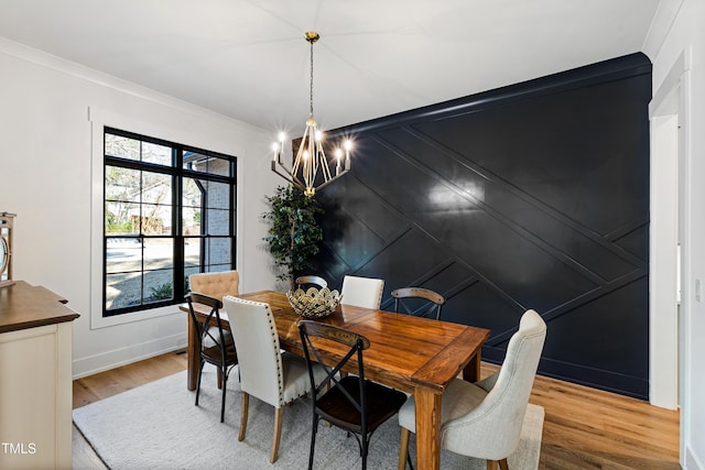 dining area with an inviting chandelier, crown molding, plenty of natural light, and wood finished floors