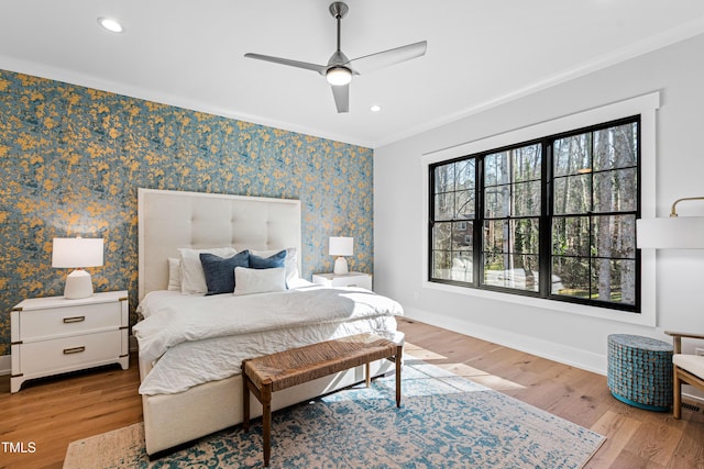 bedroom with wallpapered walls, baseboards, ornamental molding, recessed lighting, and wood finished floors