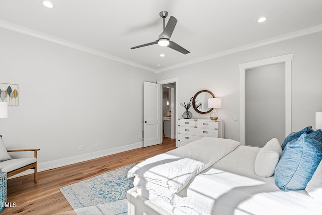 bedroom with recessed lighting, baseboards, wood finished floors, and crown molding