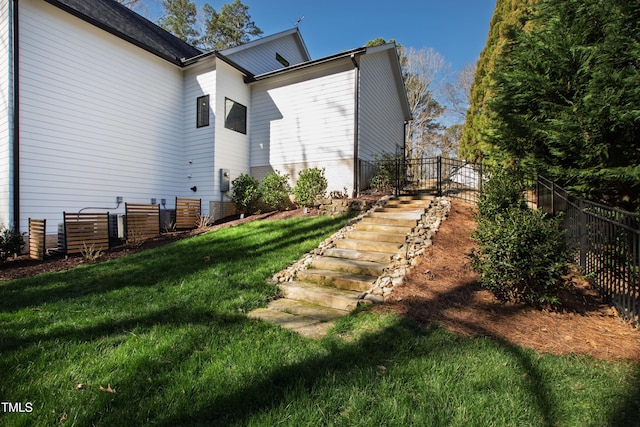 view of side of property featuring a yard and fence