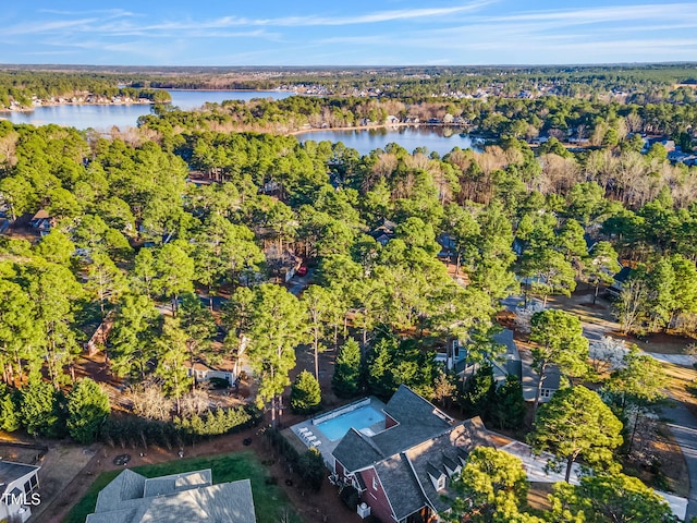 aerial view with a forest view and a water view