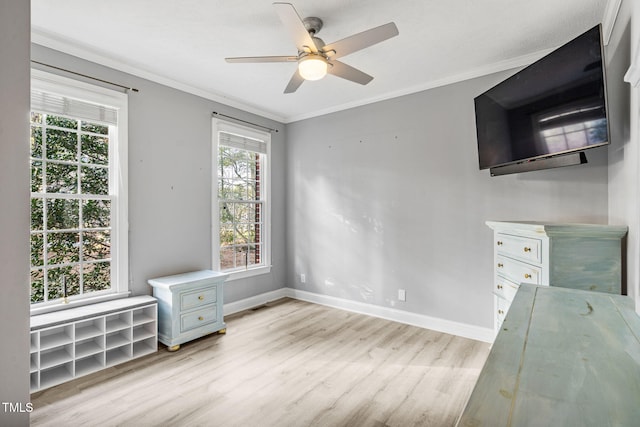 unfurnished bedroom with visible vents, light wood-style flooring, baseboards, and ornamental molding